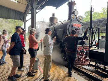 International Tourists Amaze the Charm Steam Train 