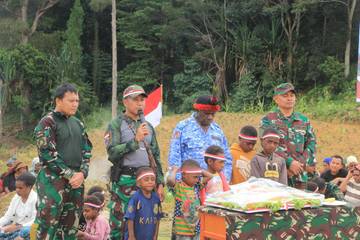  Yonif 614 Bakar Batu Bersama Masyarakat Lanny Jaya